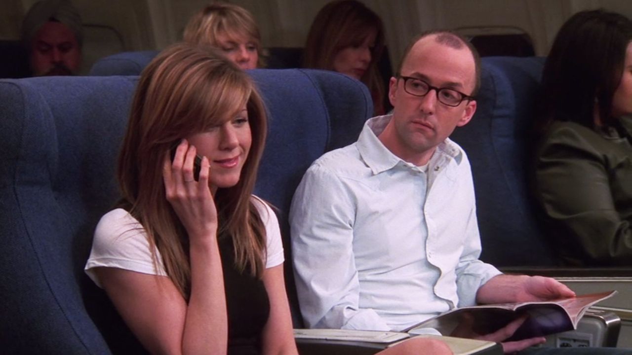 jim rash and jennifer aniston on a plane in the friends series finale