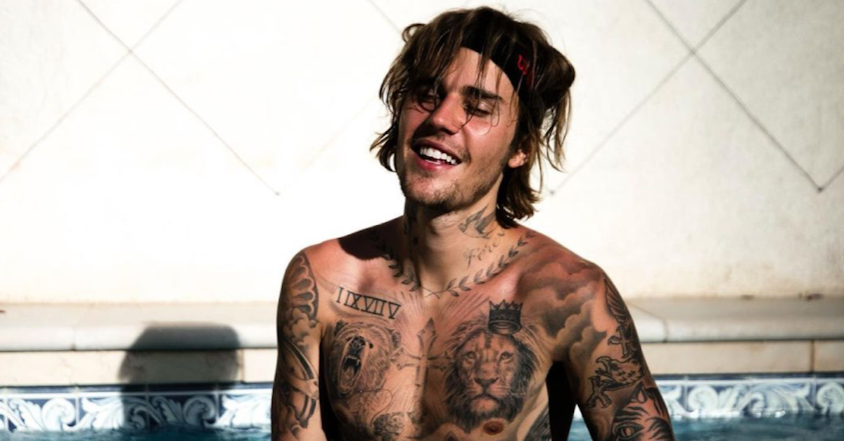 Justin Bieber Smiles Shirtlessly As He Takes A Swim In A Pool Revealing His Many Tattoos