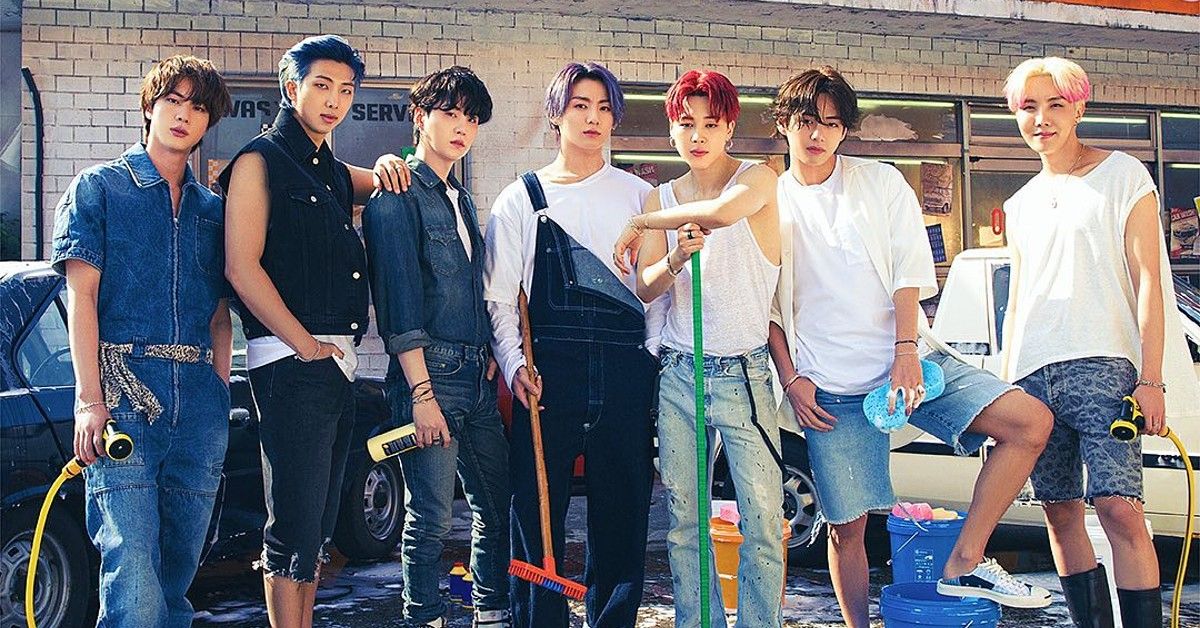 BTS members dressed in t-shirts and denim for car wash staged photo outside convenient store