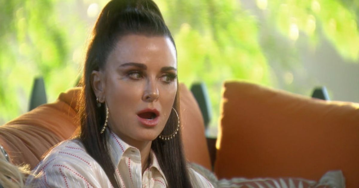 Kyle Richards looking shocked and sitting outside on The Real Housewives of Beverly Hills