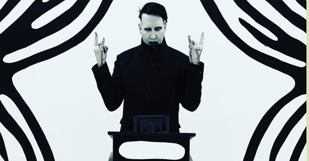 Marilyn Manson Stands In Front Of An Eerie Background
