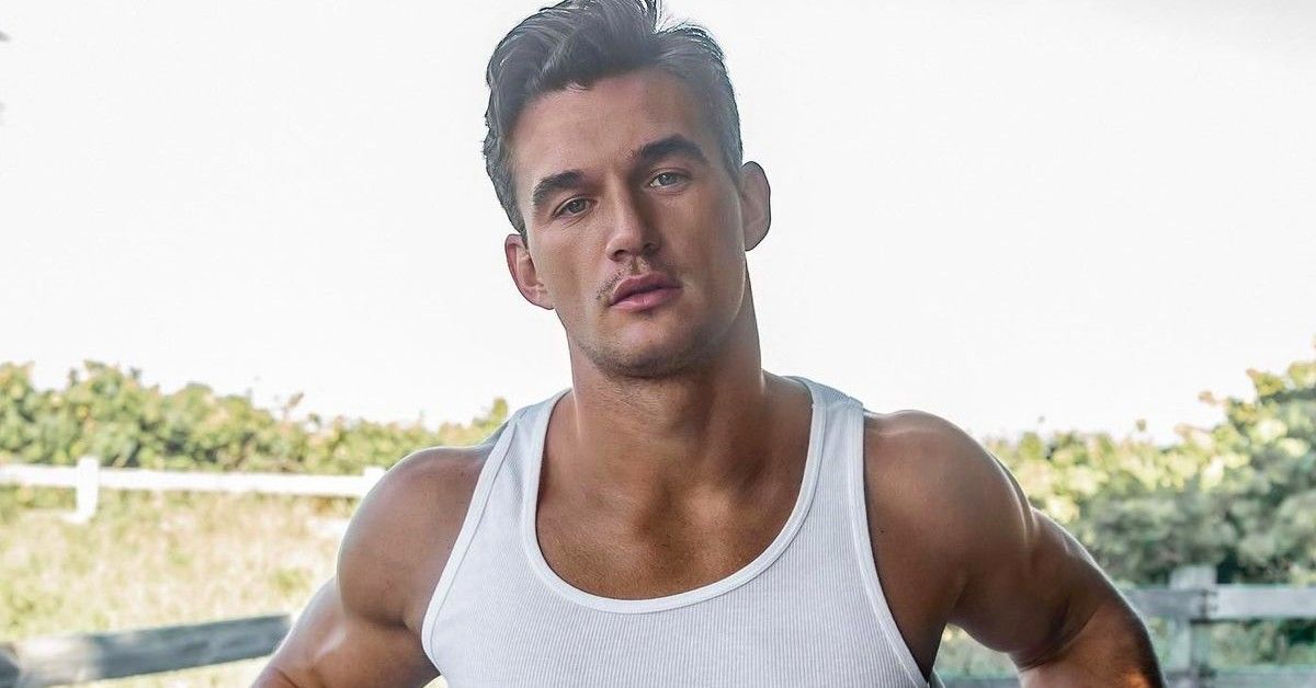Tyler Cameron poses in a white undershirt at a photoshoot