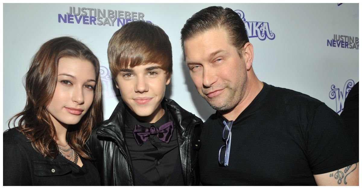 Young Hailey Baldwin and Justin Bieber posing with dad Stephen Baldwin at Never Say Never Event