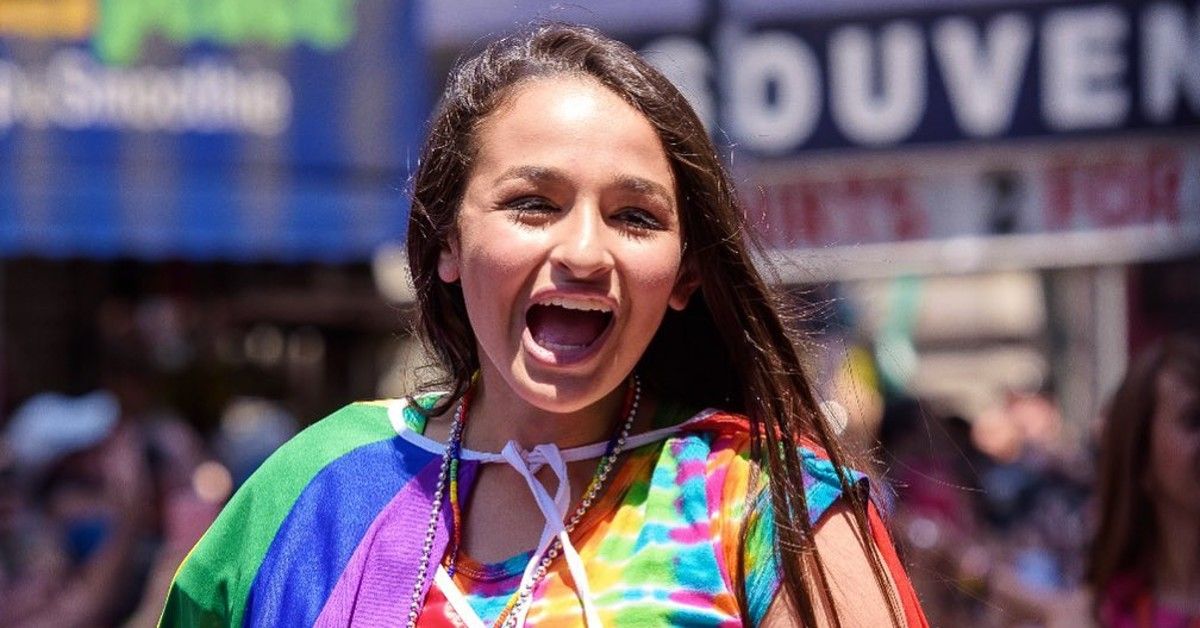 Jazz Jennings excited in rainbow shirt and rainbow cape