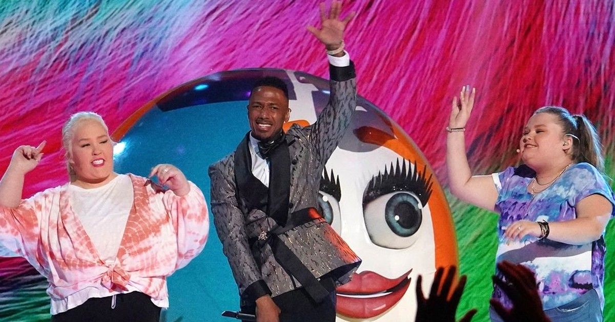 Mama June, Nick Cannon and Alana Thompson on The Masked Singer stage in front of beach ball mask
