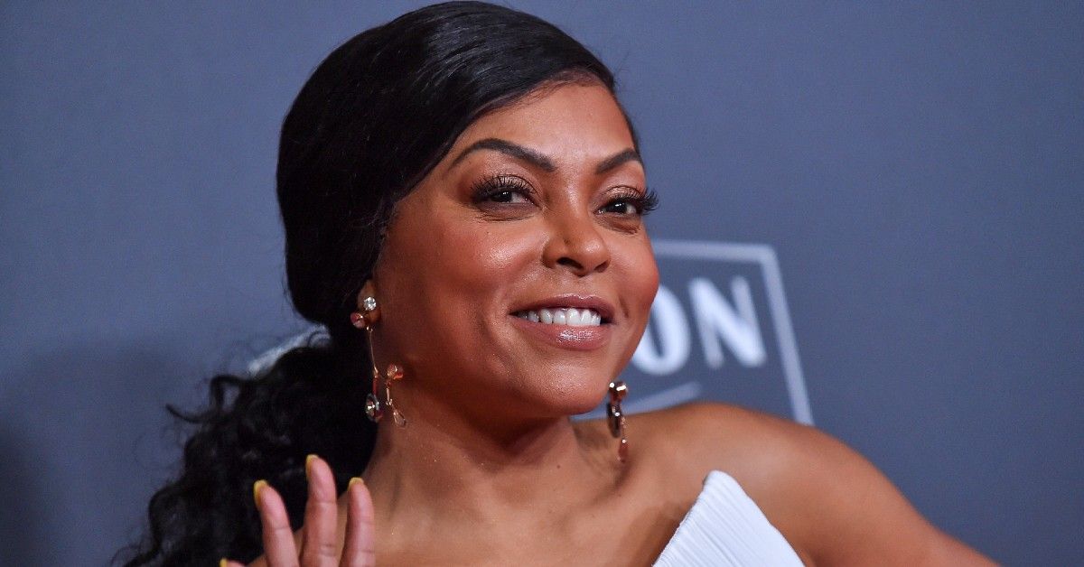 Taraji P. Henson at the 2018 Hollywood Film Awards with hair pulled back standing in front of blue backdrop