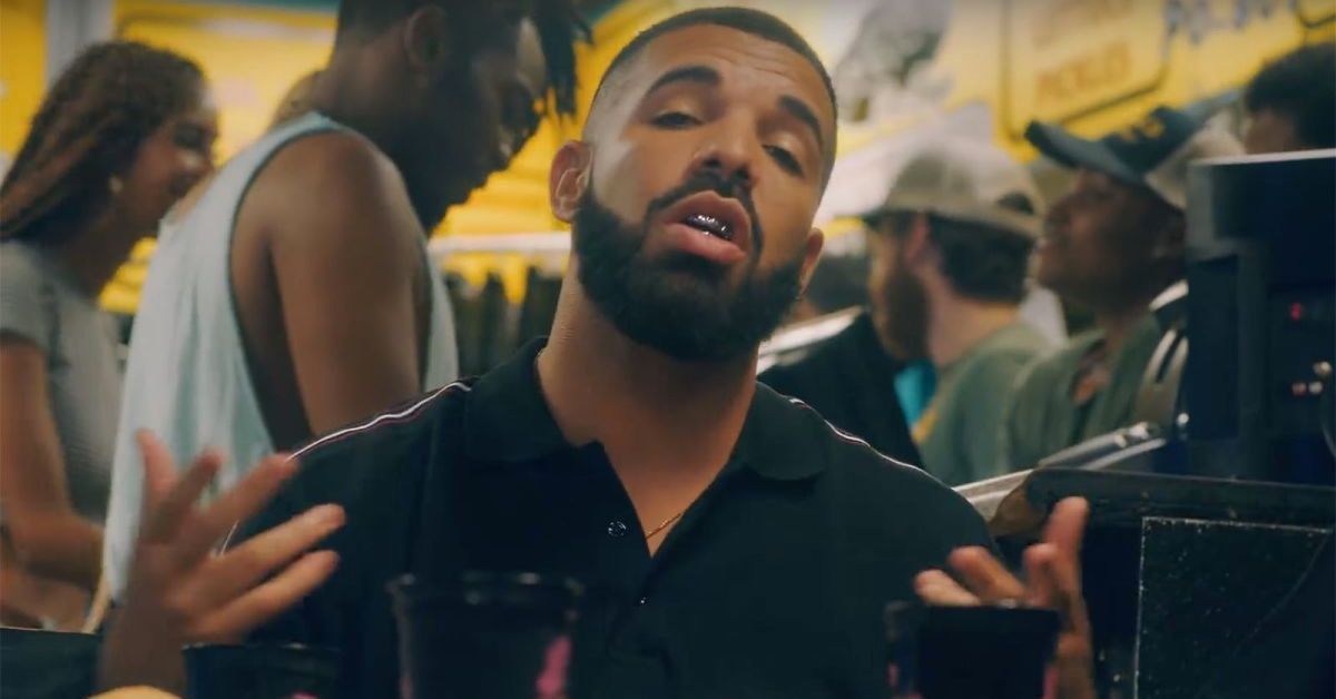 Drake in a music video wearing a black shirt