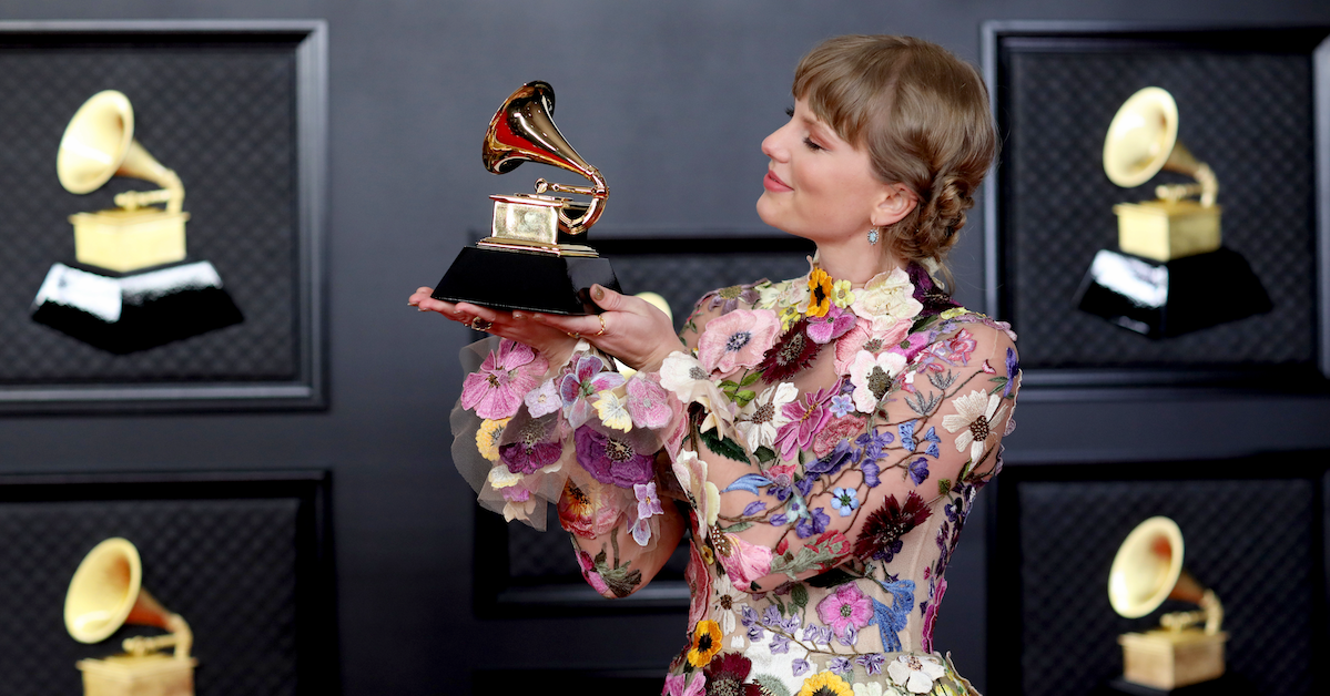 Taylor Swift with her Grammy on the red carpet at the 63rd Annual Grammy Awards