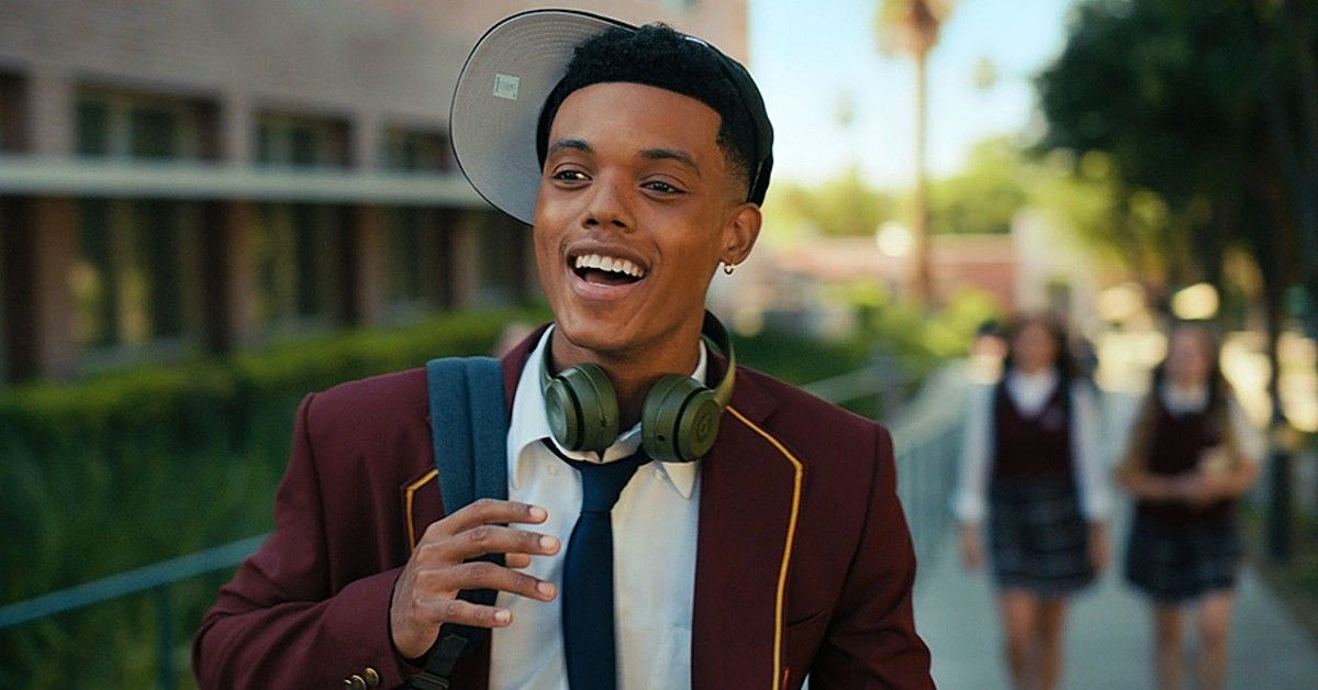 Jabari Banks dressed in private school uniform with headphones and hat on sideways for scene from Bel-Air