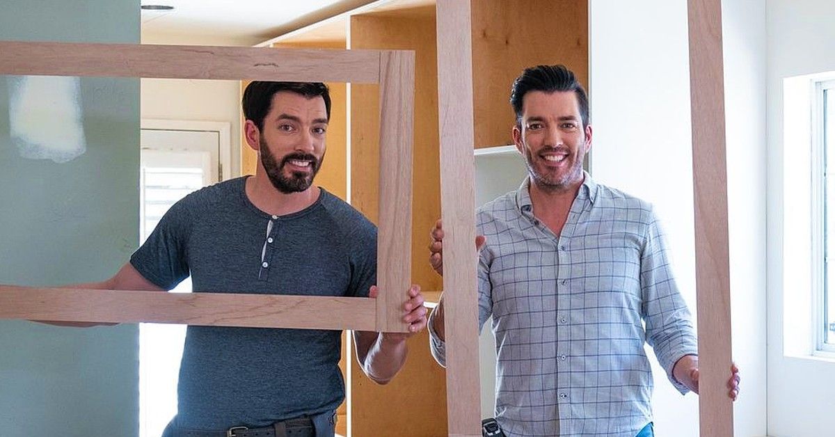 Drew and Jonathan Scott posed with rectangular wooden frames during the renovation