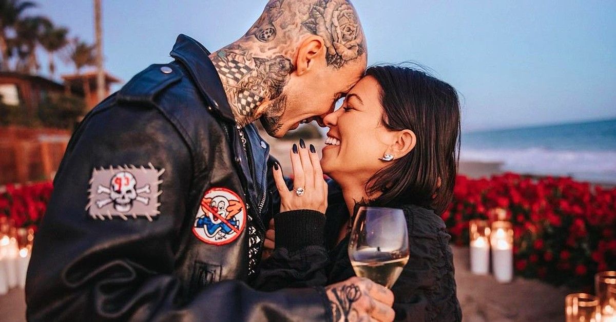 Kourtney Kardashian and Travis Barker face to face among roses and candles at the beach for engagement