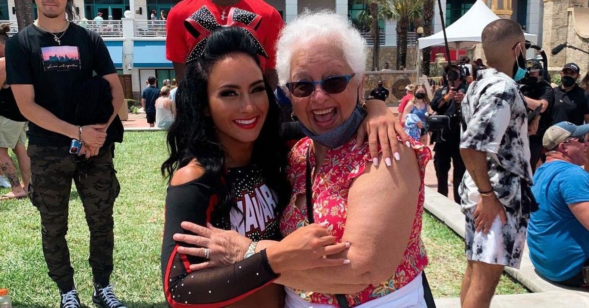 Gabi Butler in Navarro Cheer uniform posing with her grandma outside