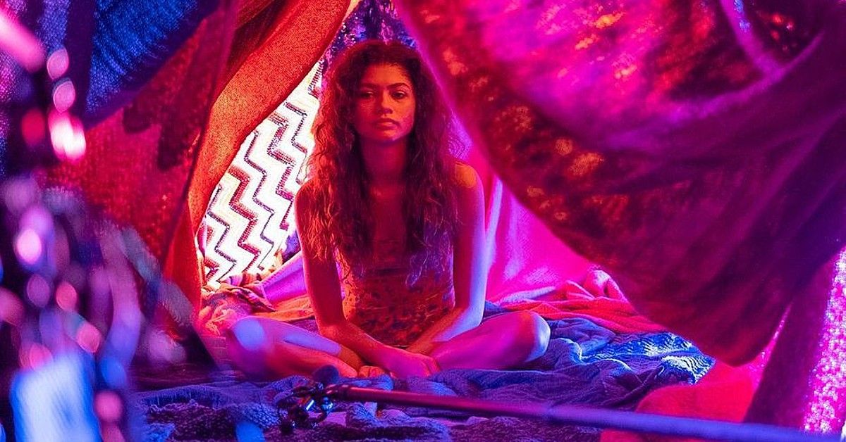 Zendaya in purple and pink lighting and blanket tent for Euphoria