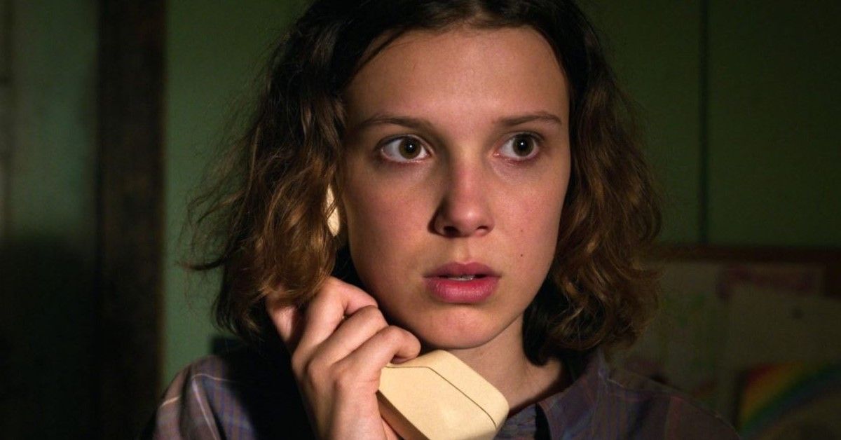 Millie Bobby Brown as Eleven holds a phone in a scene of Netflix series Stranger Things 