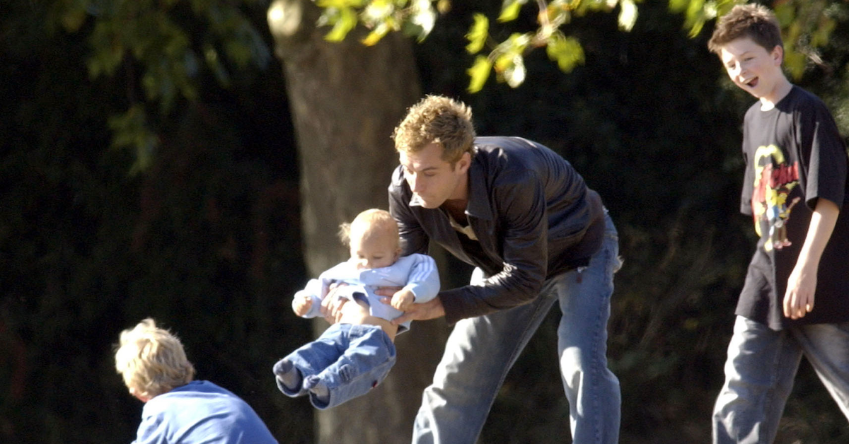 Actors Jude Law playing with his children