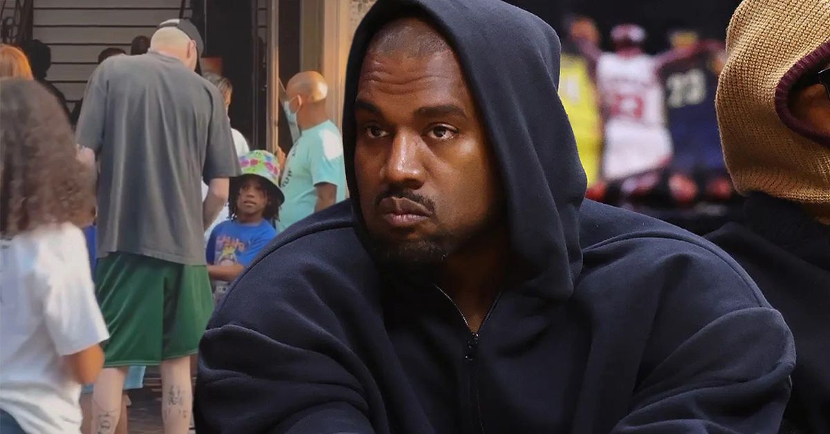 Kanye West courtside at a basketball game looking stern