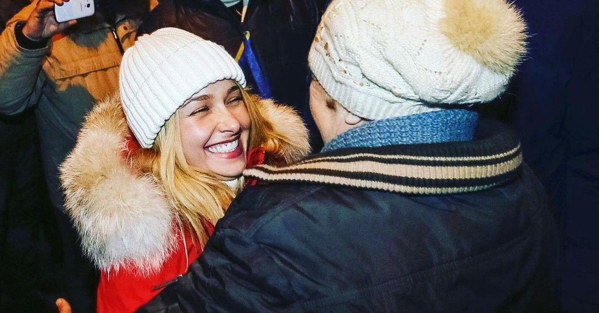 Hayden Panettiere in red fur coat and white beanie
