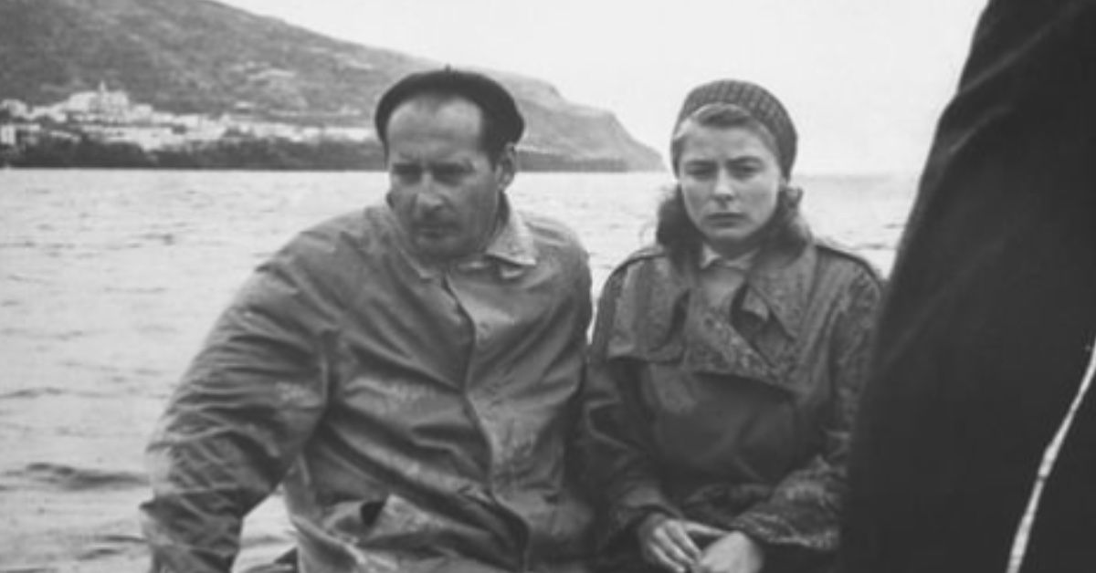 Roberto Rossellini and Ingrid Bergman sit in a boat behind the scenes of Stromboli.