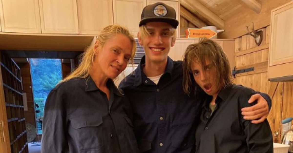A picture of Uma Thurman (right), her son Levon Thurman-Hawke and daughter Maya Hawke. They are standing and hugging each other, with Uma and Levon smiling at the camera while Maya is pulling a face, her hair covering part of her face.