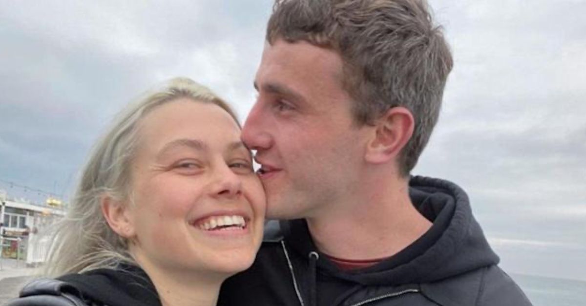 Singer Phoebe Bridgers and actor Paul Mescal pose for a selfie. She's smiling and looking to the camera, while he's showing his profile, with his face close to hers.