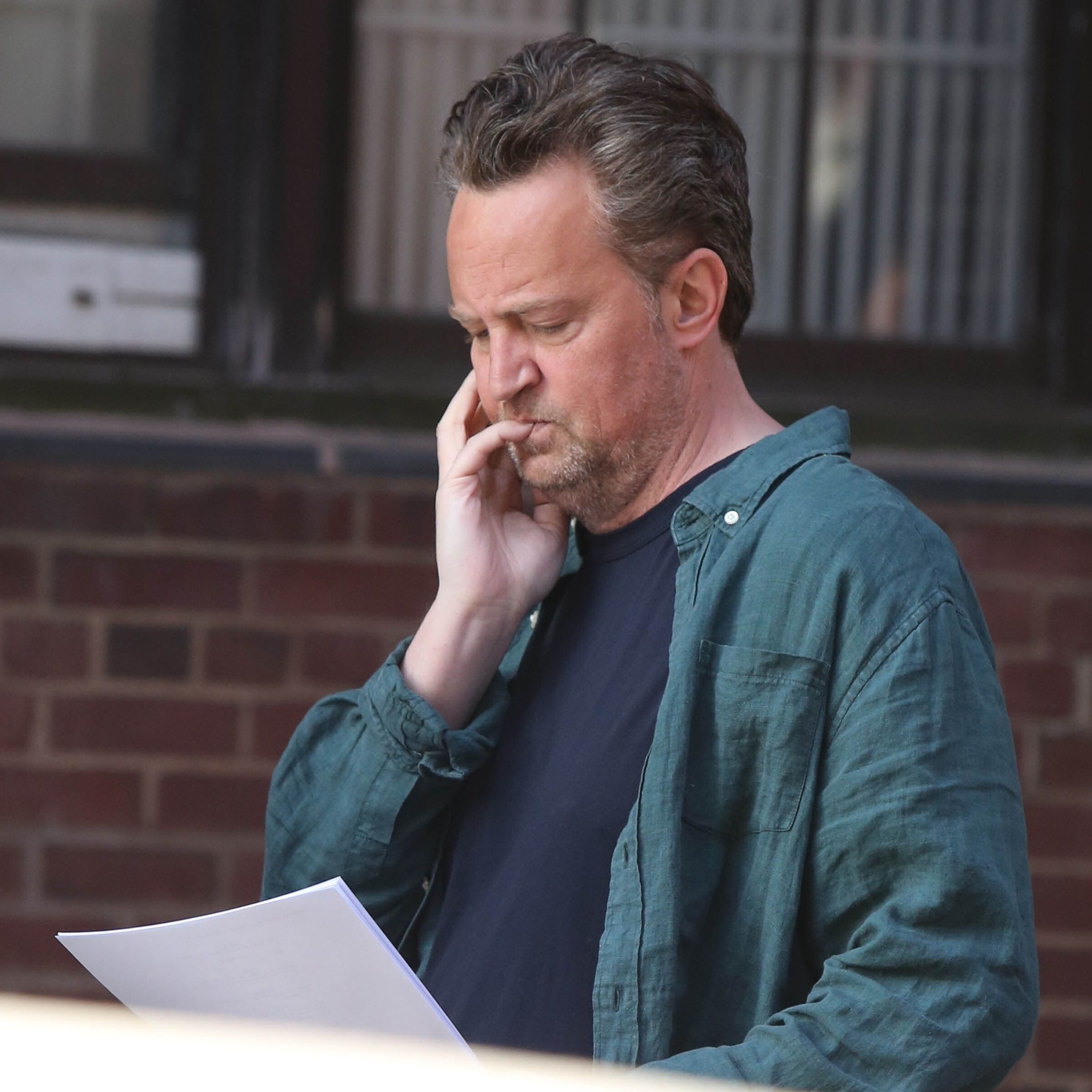 Matthew Perry reads the papers in New York