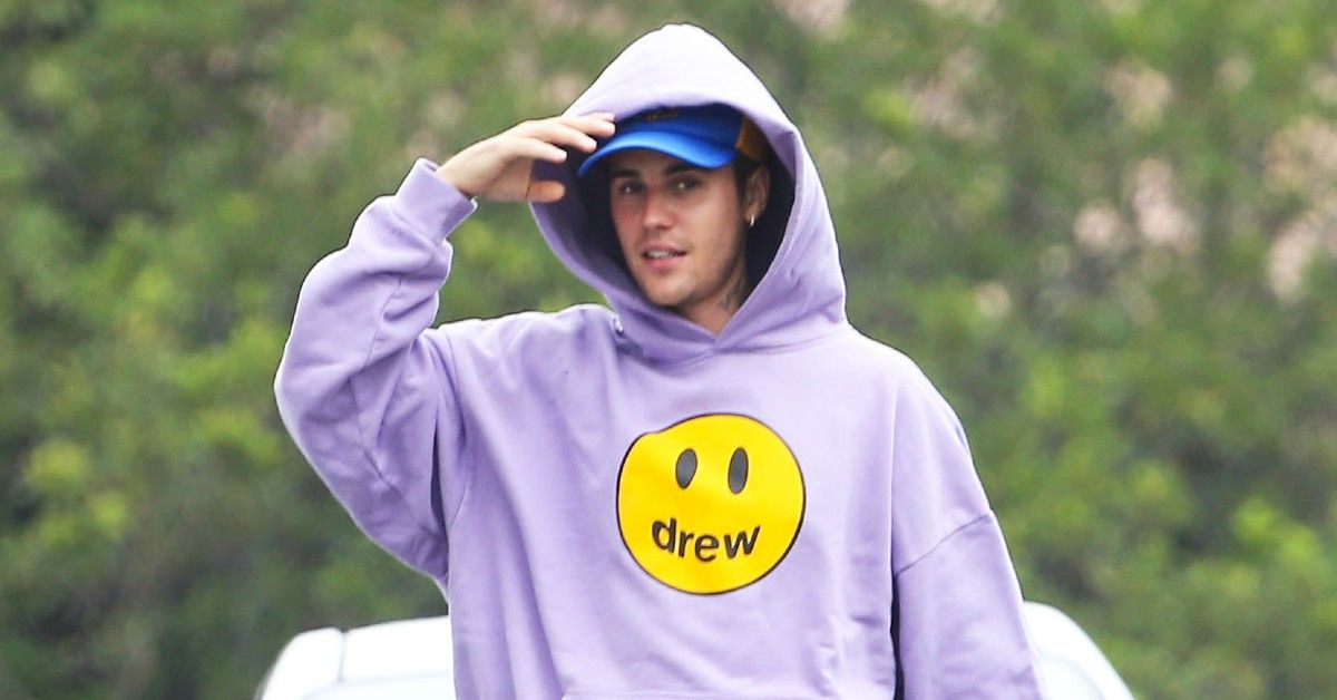 Justin Bieber wearing a purple hoodie outside