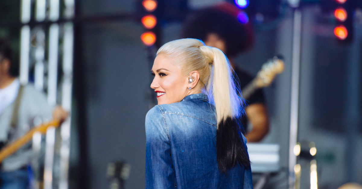 Gwen Stefani with ponytail black tips and jean jacket on stage