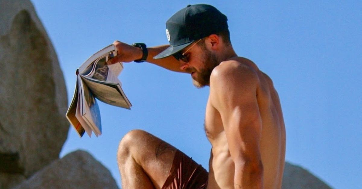 Zac Efron Brother Dylan shirtless reading on a rock