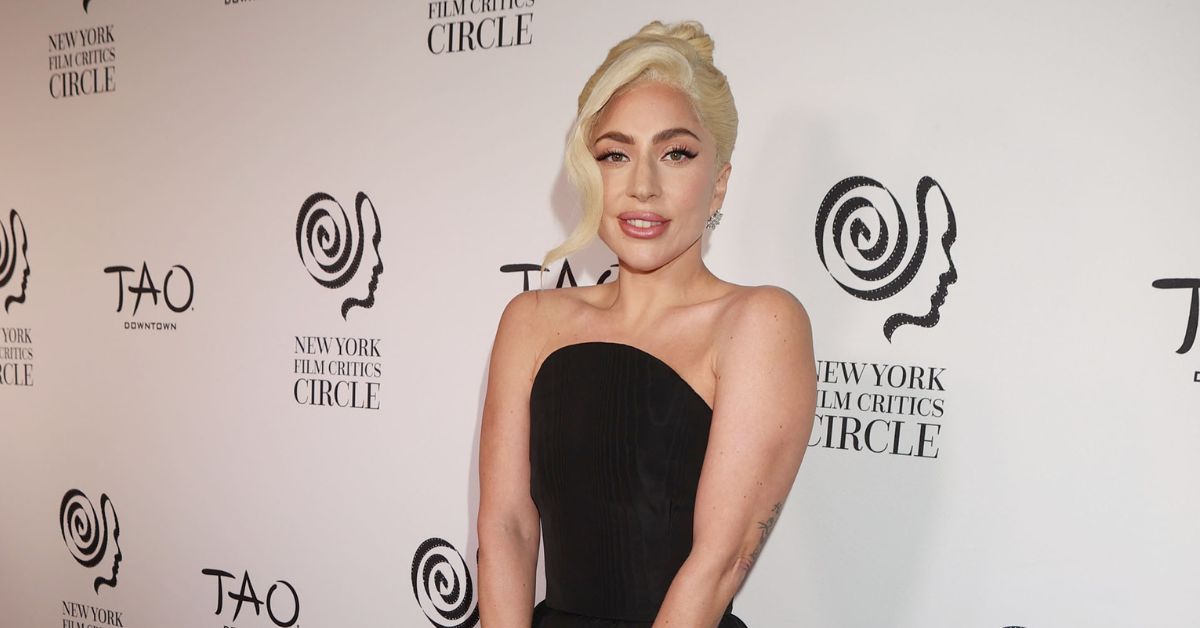 Lady Gaga posing on the red carpet in a black dress