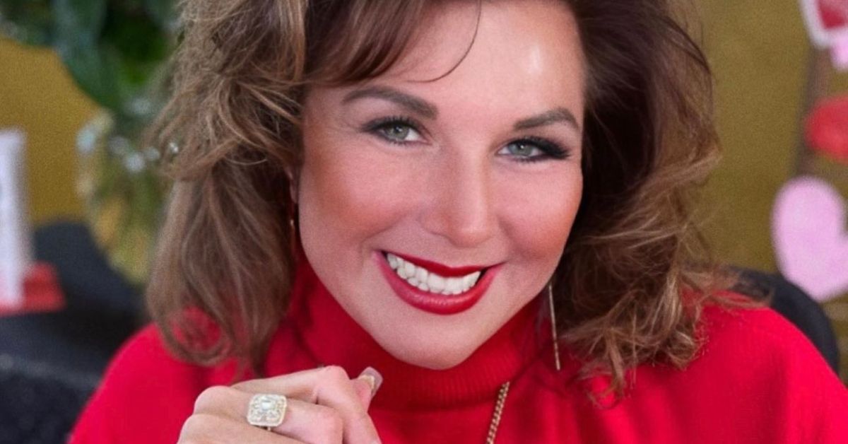 Abby Lee Miller smiling wearing a red top