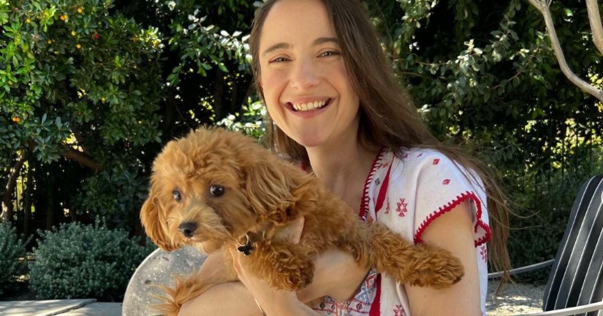 Alexa Nikolas smiling holding her dog