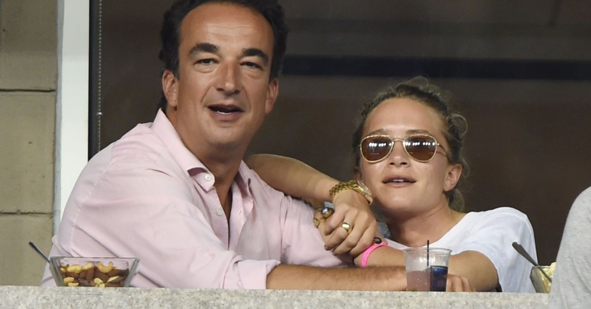 Olivier Sarkozy and Mary-Kate Olsen sitting at a tennis match