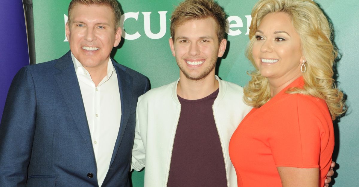 Todd, Chase and Julie Chrisley smiling on the red carpet for NBC Universal Summer Press Tour