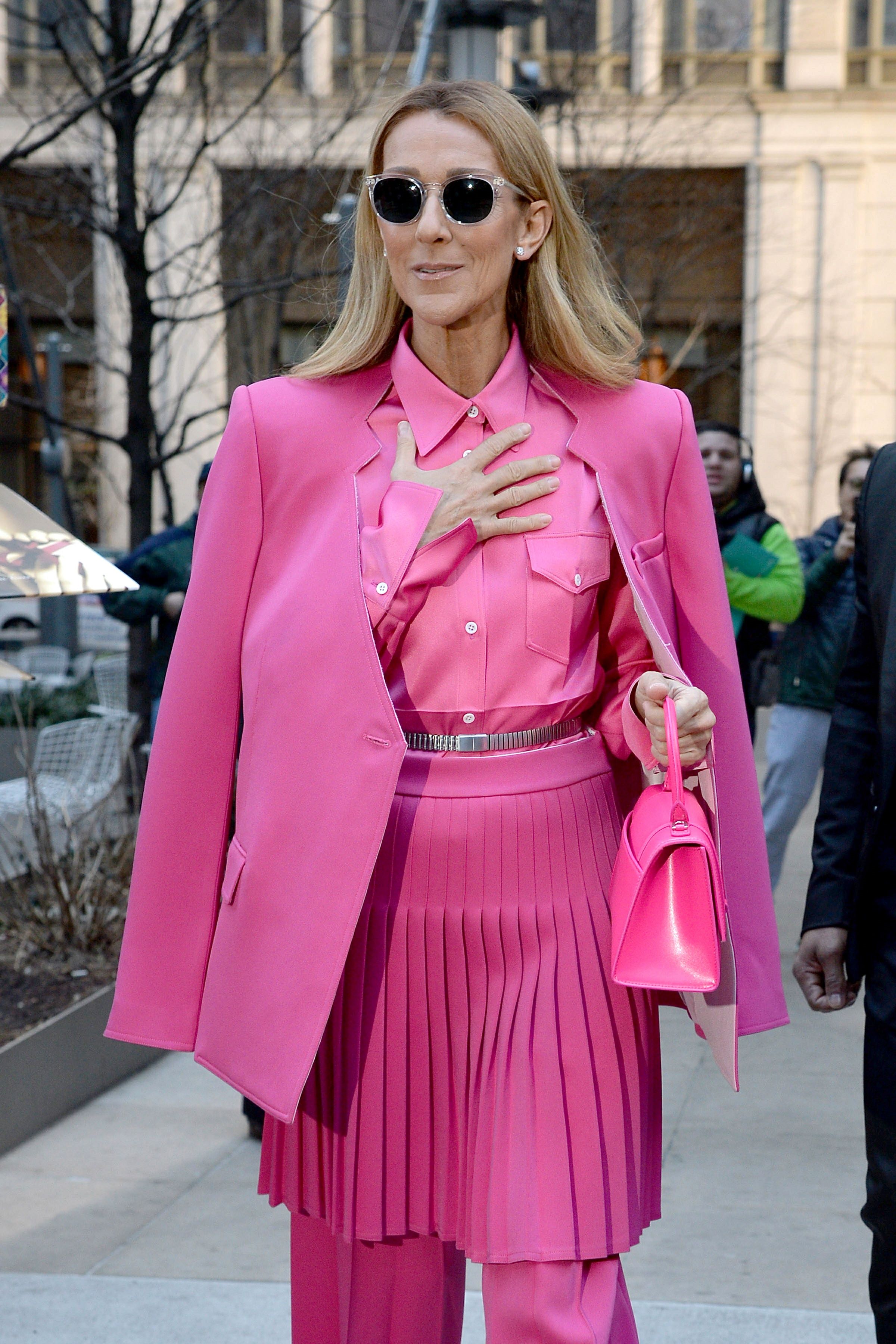 Celine Dion in pink outfit leaving hotel