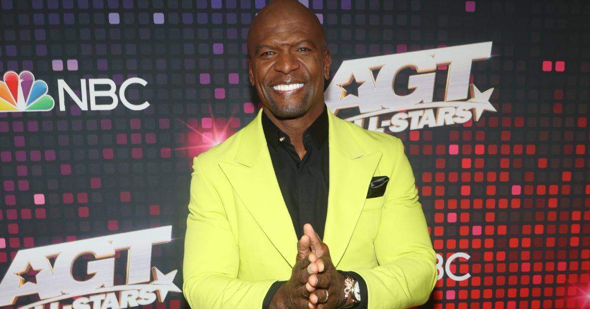 Terry Crews smiling in a suit