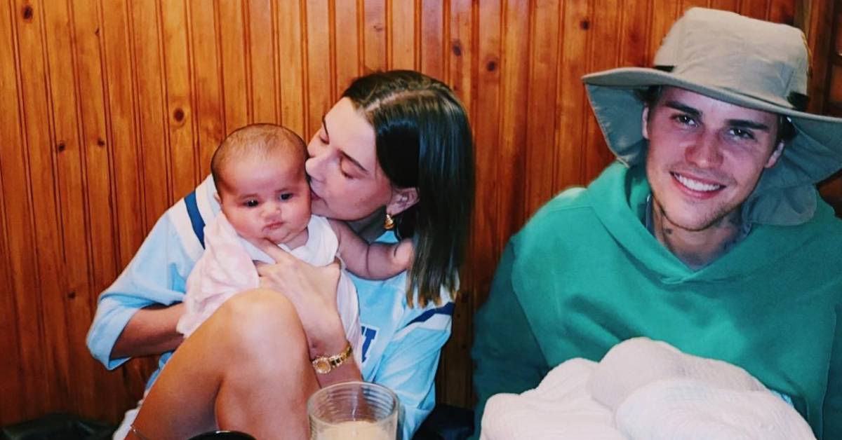 Hailey Bieber holding a baby with Justin Bieber