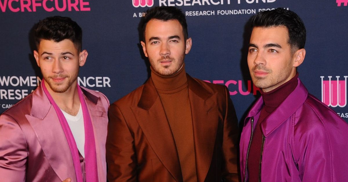 Jonas Brothers wearing suits on the red carpet