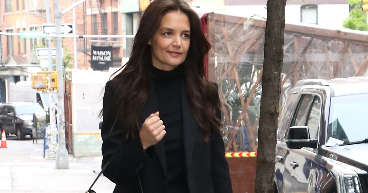 Katie Holmes smiling and walking outside