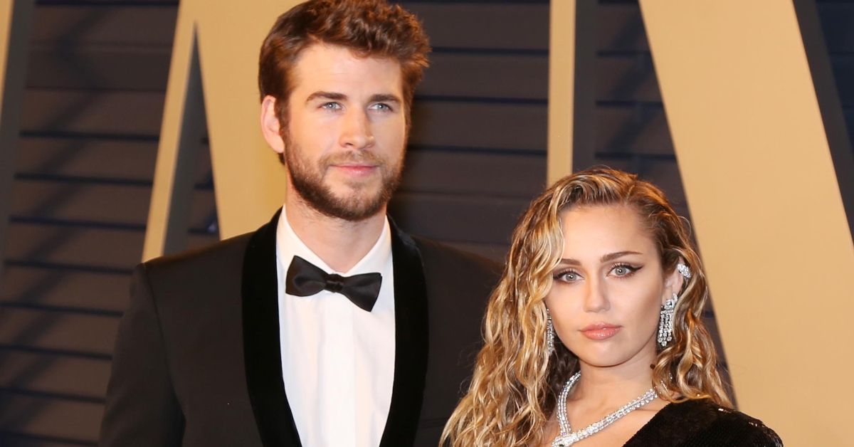 Liam Hemsworth and Miley Cyrus attending event 