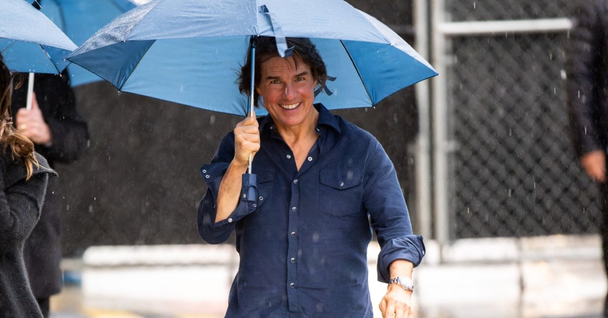 Tom Cruise smiling walking in the rain