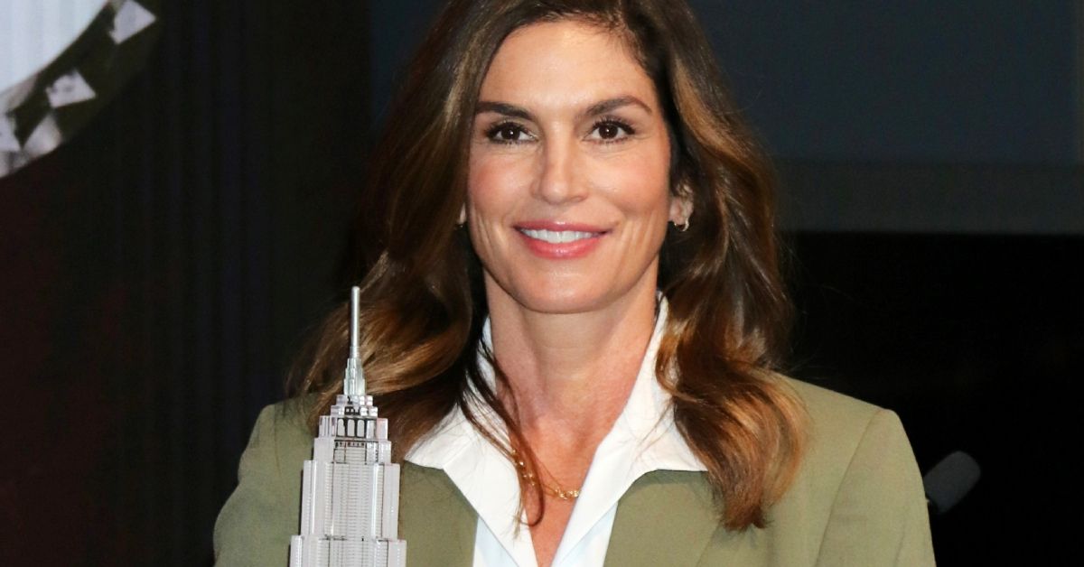 Cindy Crawford smiling in a formal outfit 