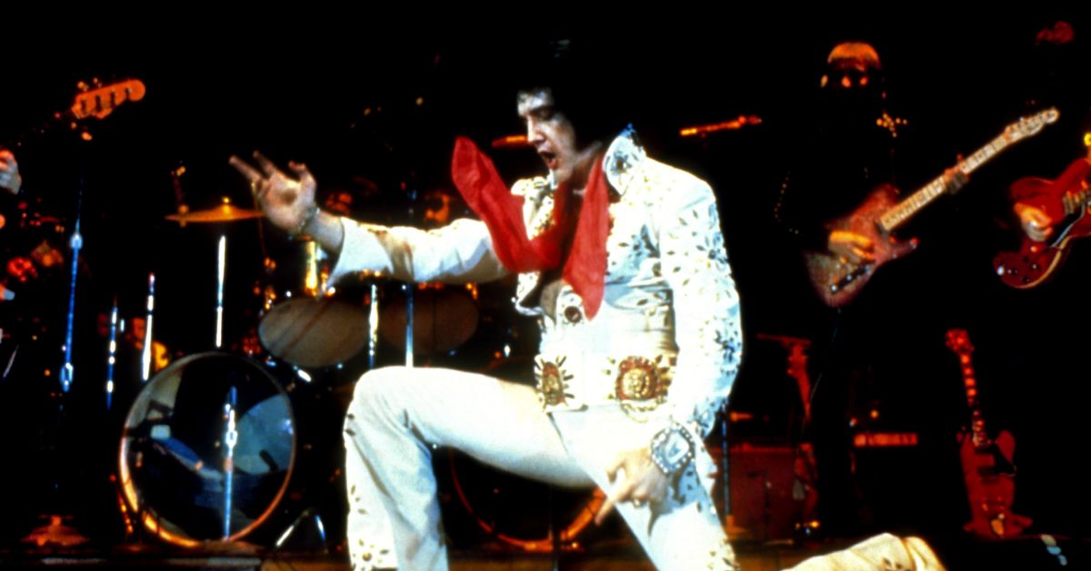 Elvis Presley on one knee during a performance