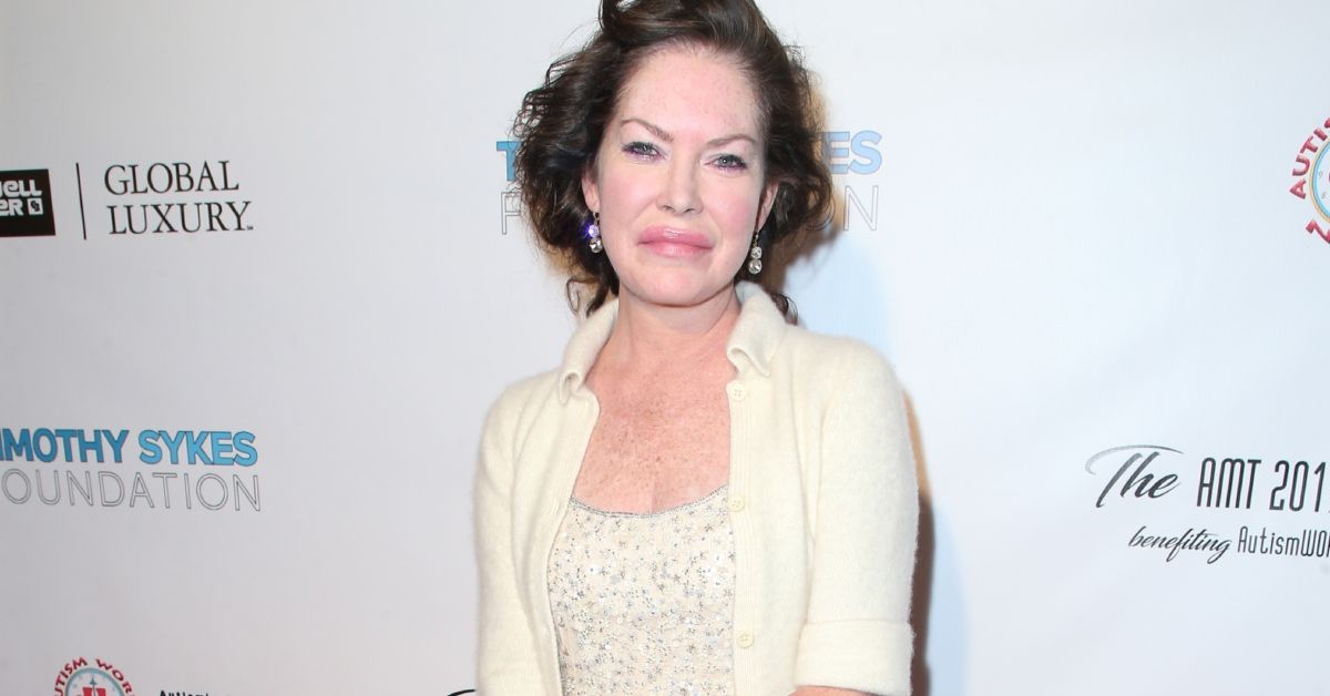 Lara Flynn Boyle dressed in a white outfit on the red carpet of an event