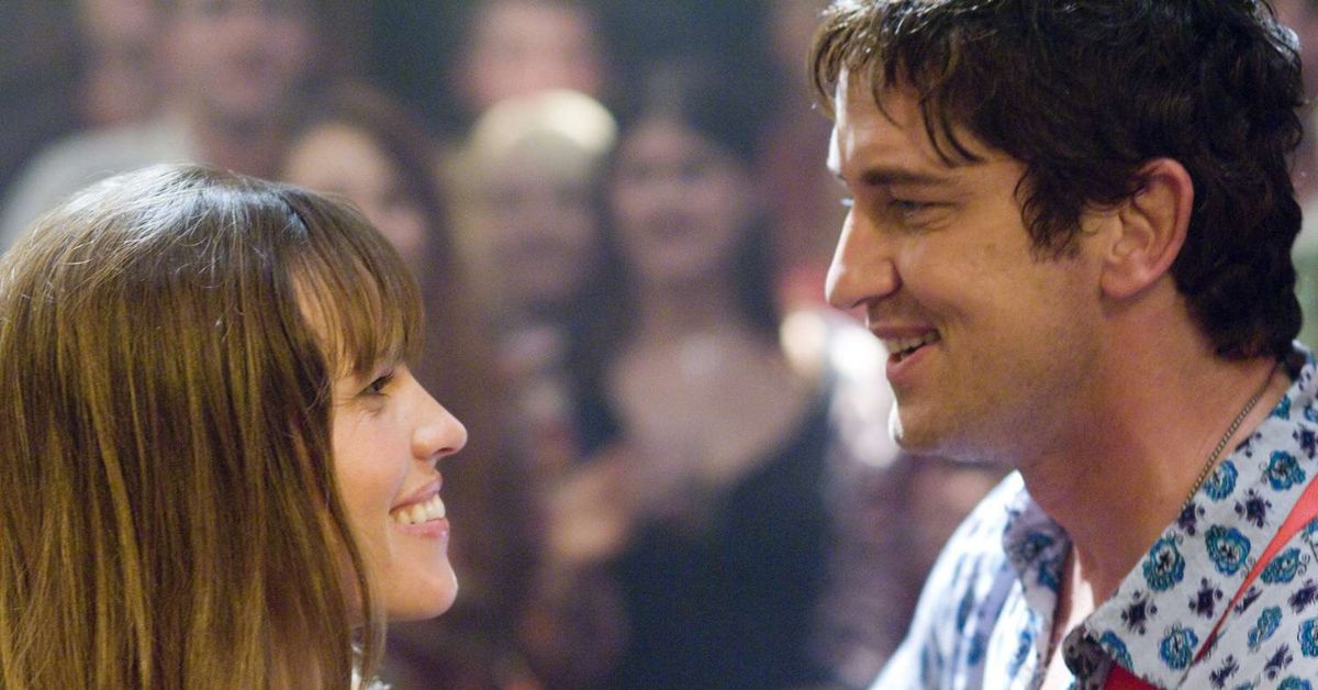 Gerard Butler and Hilary Swank smiling at each other during a scene from P.S. I Love You