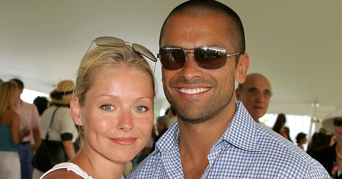 Kelly Ripa and Mark Consuelos standing together at an event