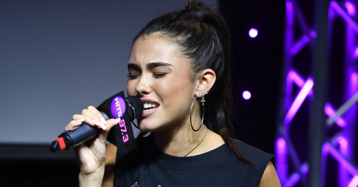 Madison Beer singing into a microphone