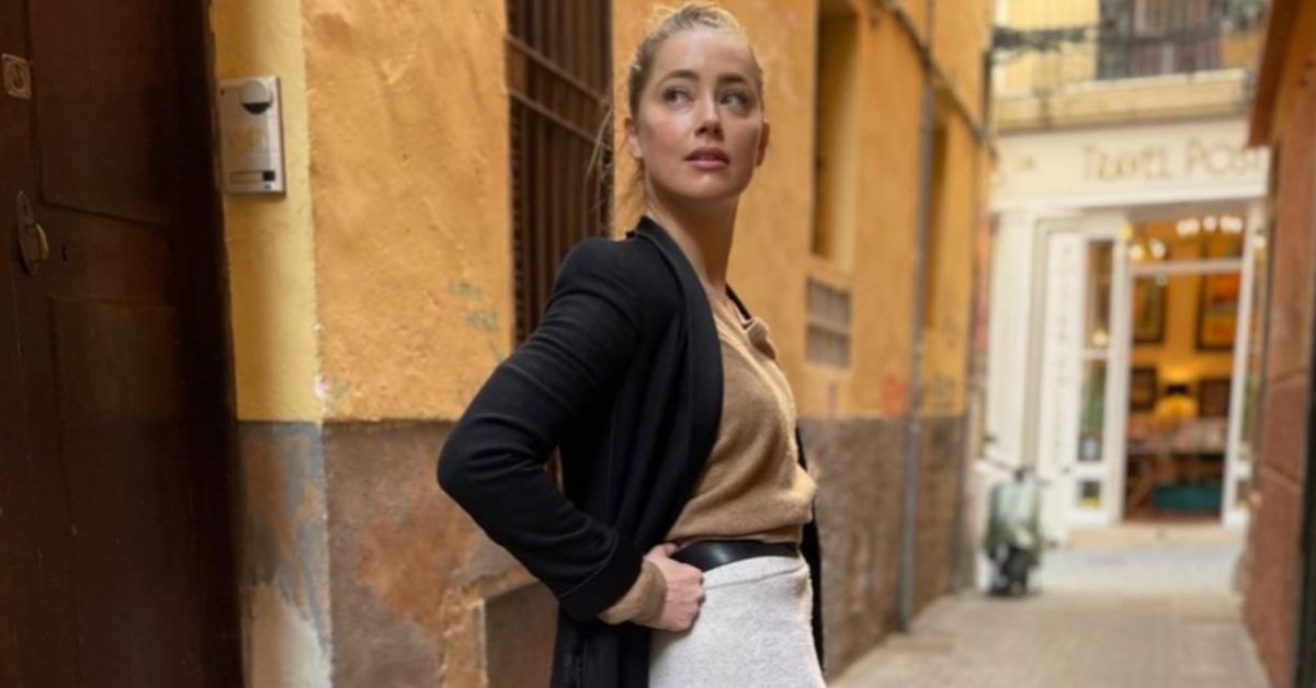 Amber Heard standing near buildings in Spain