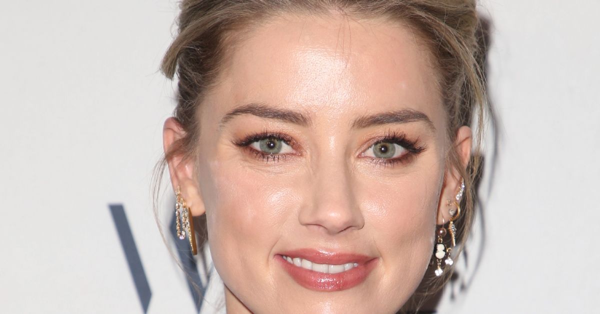 Amber Heard smiling on a red carpet