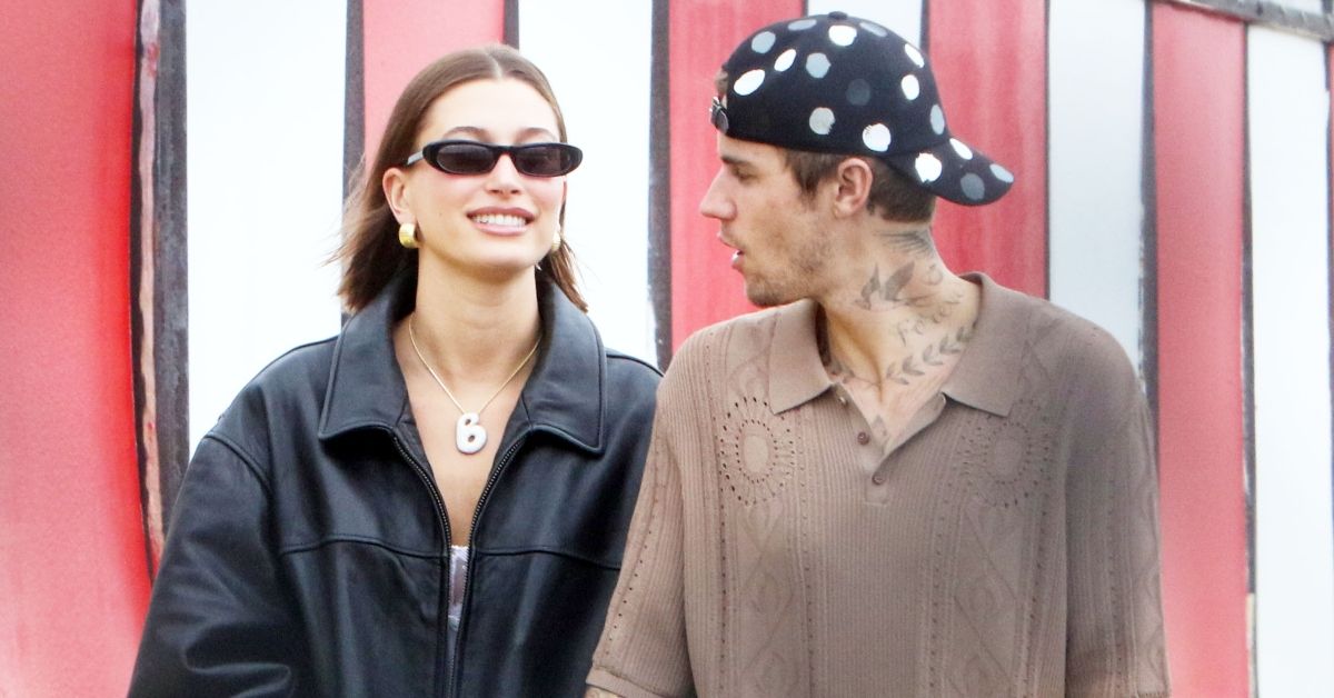 Hailey Bieber smiling while walking with Justin Bieber