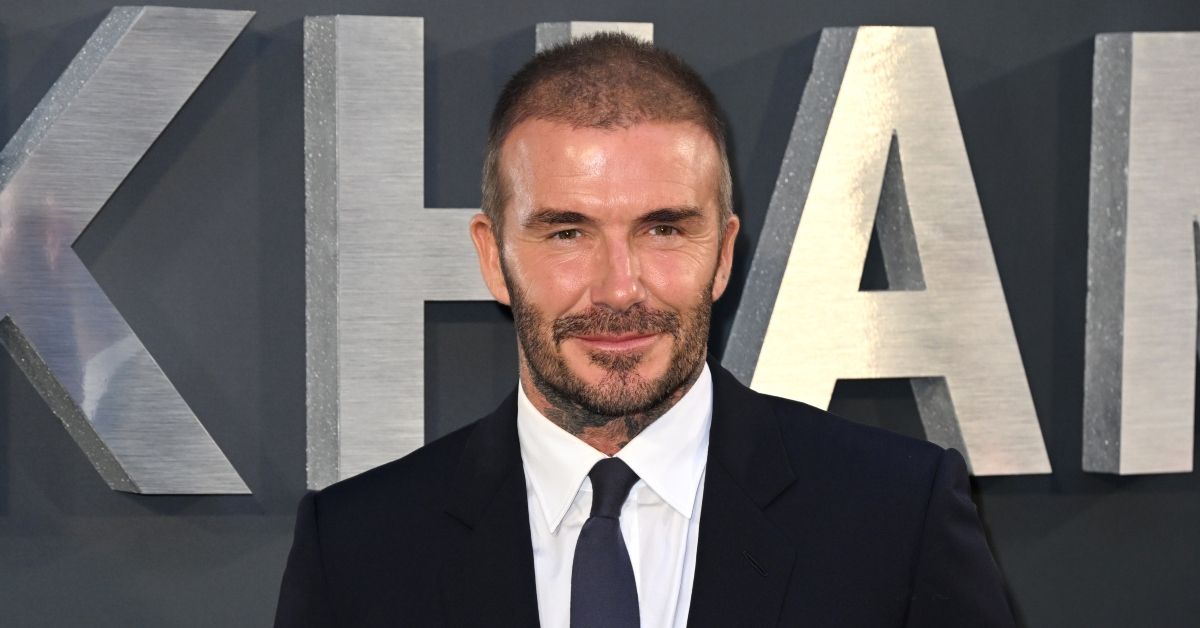 David Beckham posing in a suit on the red carpet